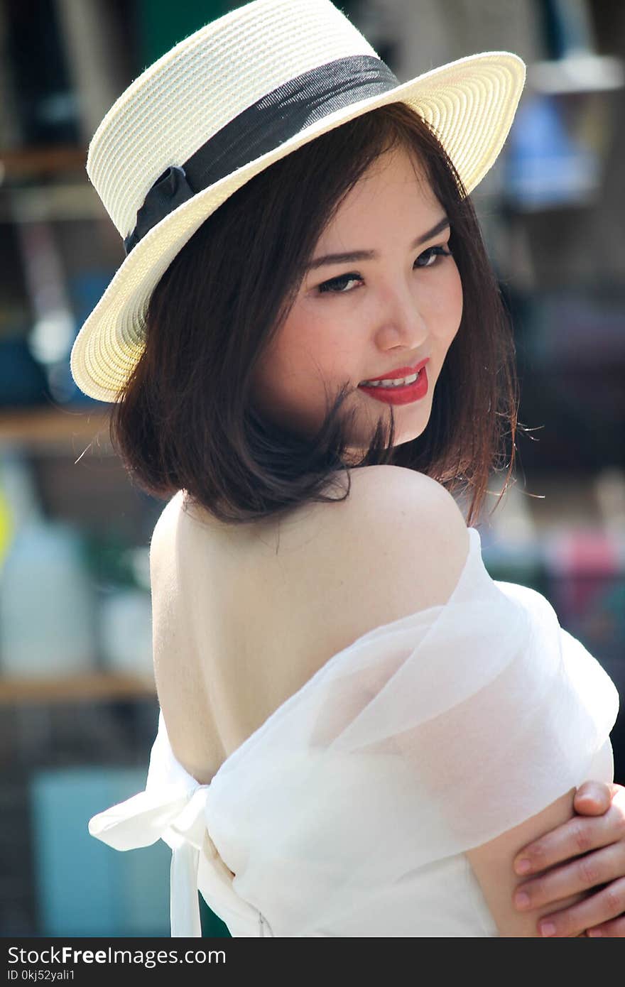 Woman In Brown Fedora Hat And White Off-shoulder Dress