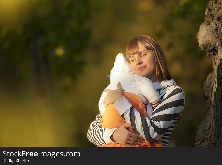 Selective Focus Photo Of Woman Carrying Baby