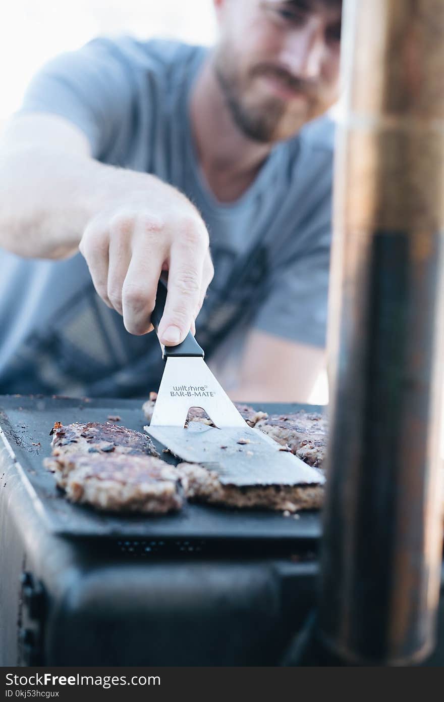 Man In Grey Crew-neck Shirt Frying Burgers