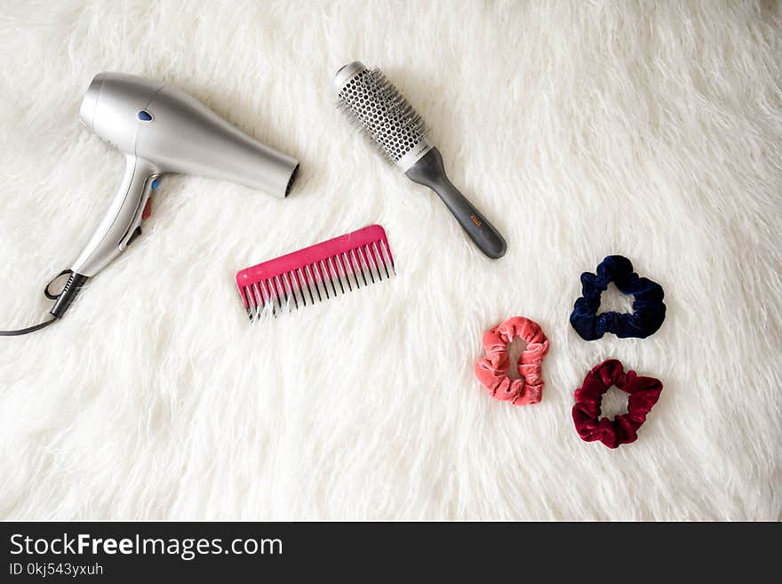 Grey Hair Blower Near Pink Hair Combs and Scrunchies