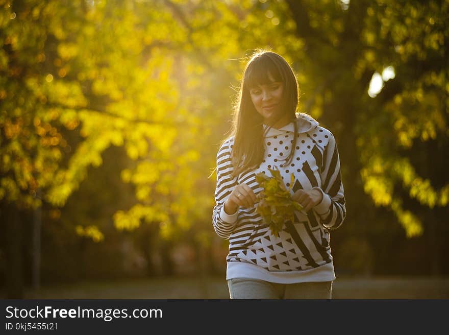 Woman Holding Leaves