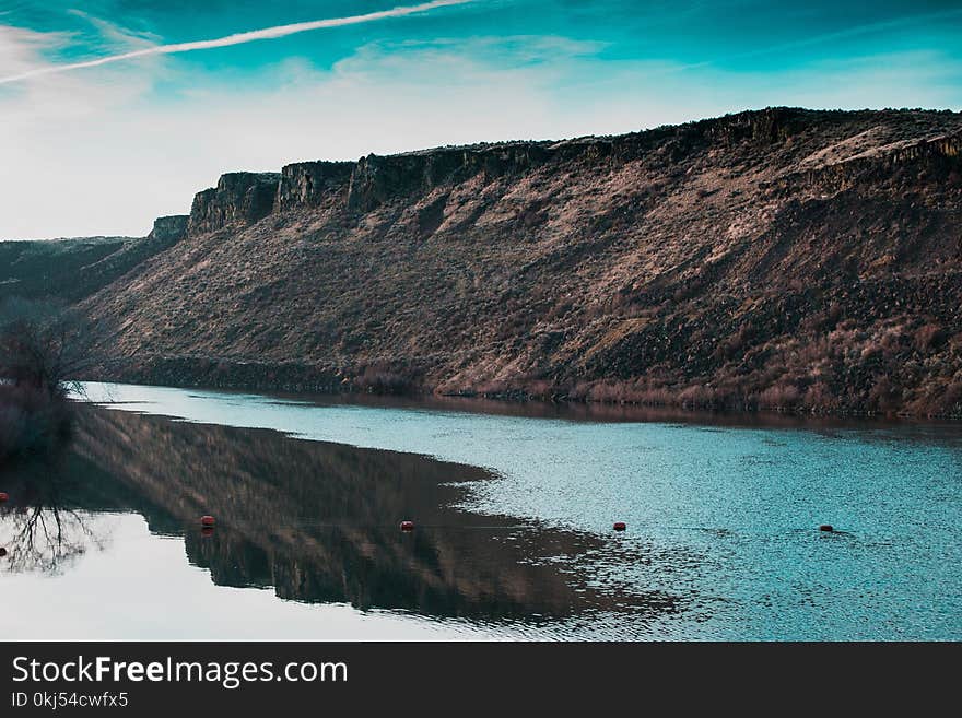 Body of Water Near Rock Formation