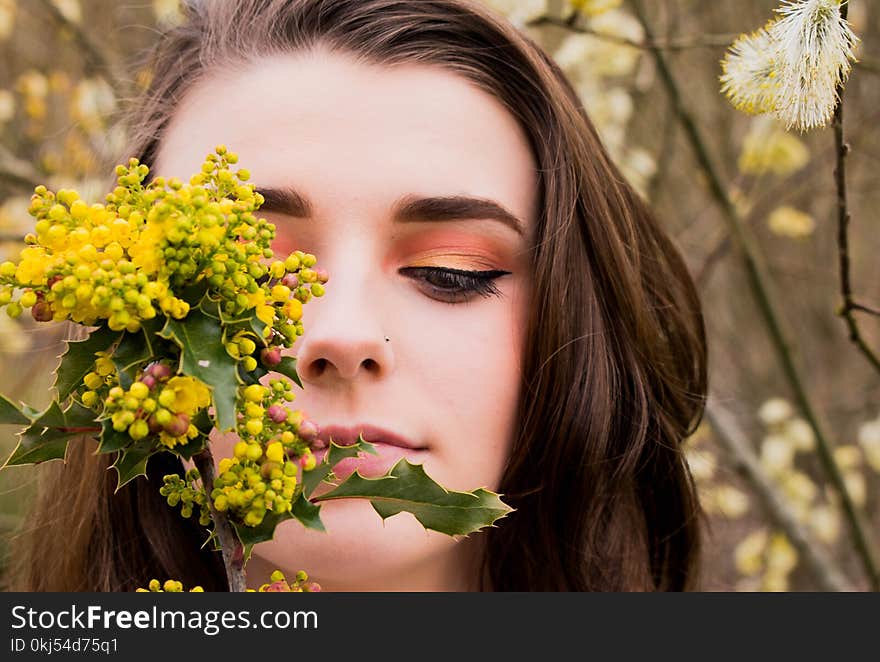 Woman Looking at a Green and Yellow Leafed Plant