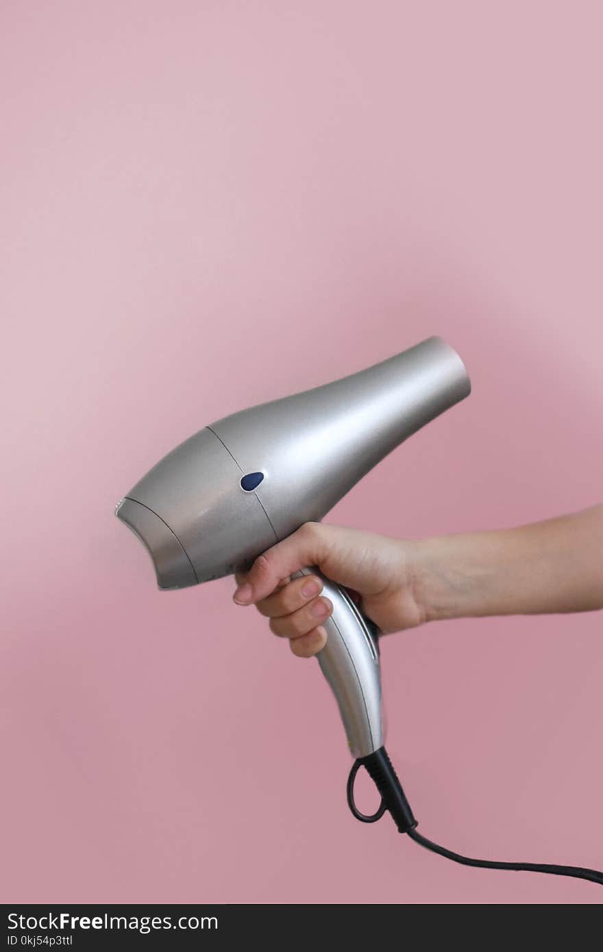 Person Holding Grey Hair Dryer