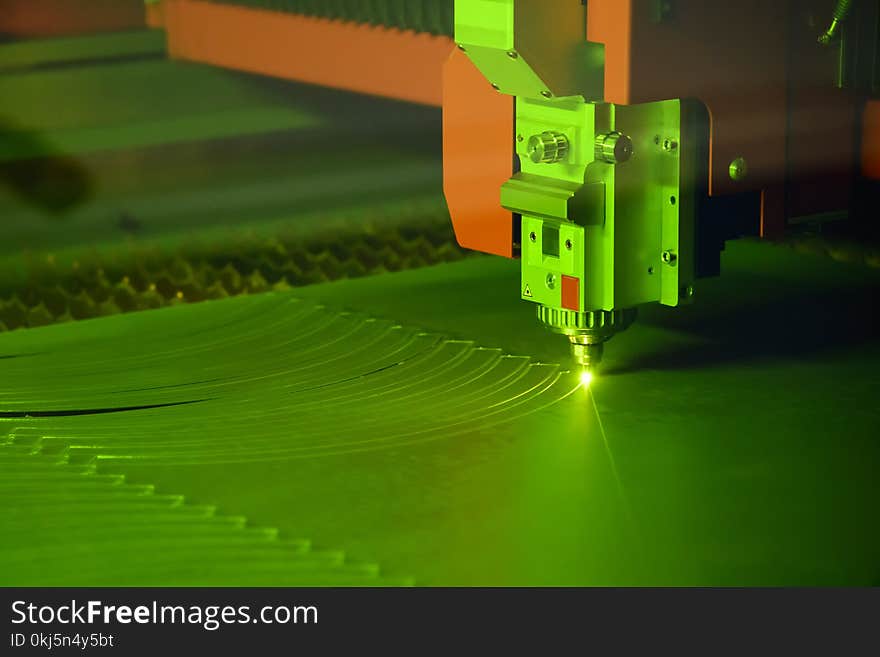 Close-up of the laser cutting machine cutting the stainless plate.