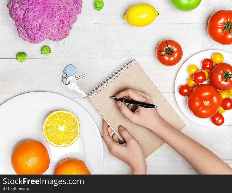 Nutrition Diet Food. Woman Writing Product Plan On Paper With Vegetables And Fruits On White Table. High Resolution