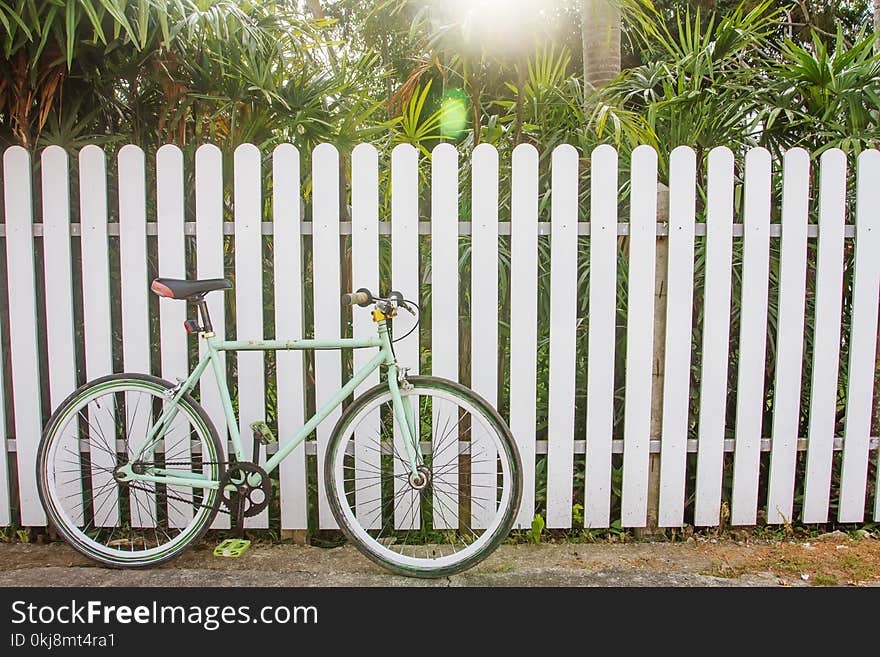 Bicycle And Wooden Fence, Which As The Background.