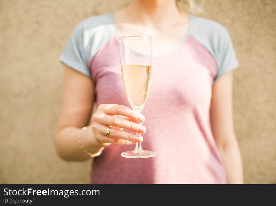 Female hand holds a glass of champagne