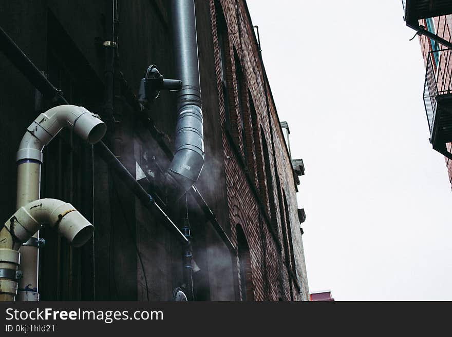 Gray Pipe on Building Wall