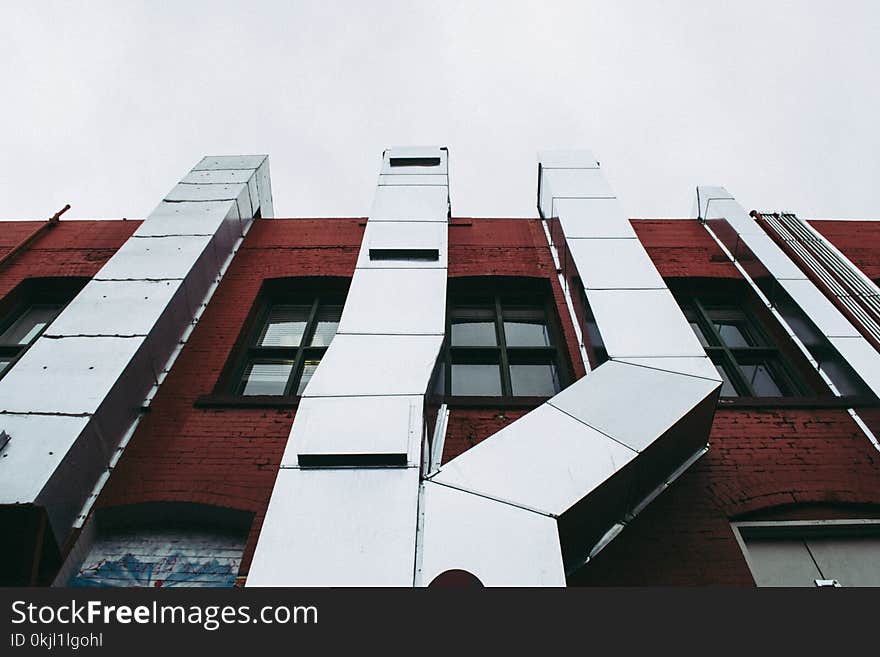 Brown Concrete Building With Grey Air Ventilatios