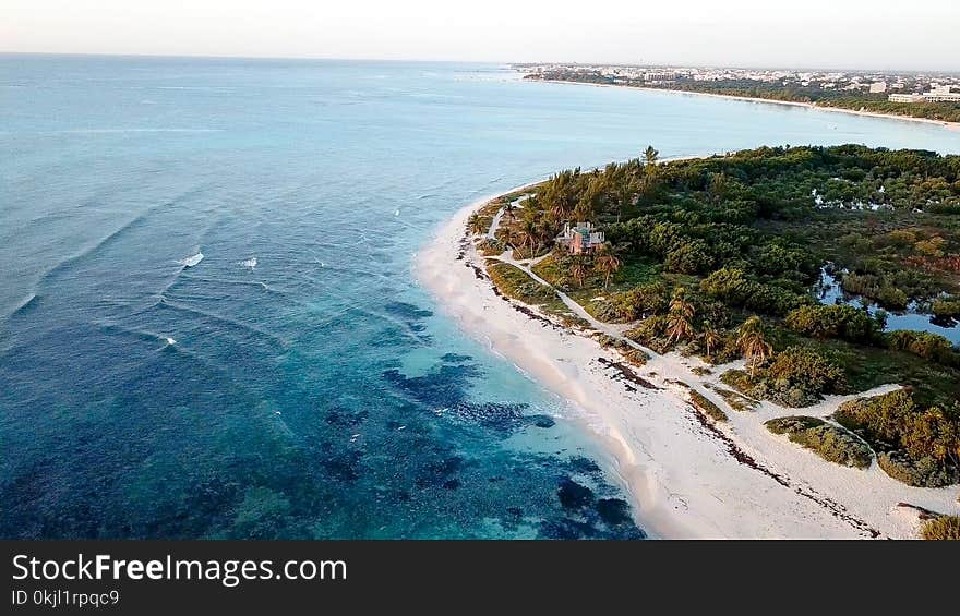 Aerial View of White Sand Beach With Green Trees and Clear Crystal Water