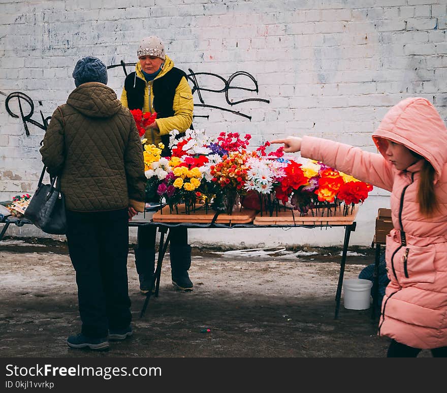 Woman in Pink Full-zip Hoodie Holding Multicolored Flowers