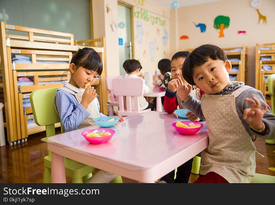 Three Toddler Eating on White Table