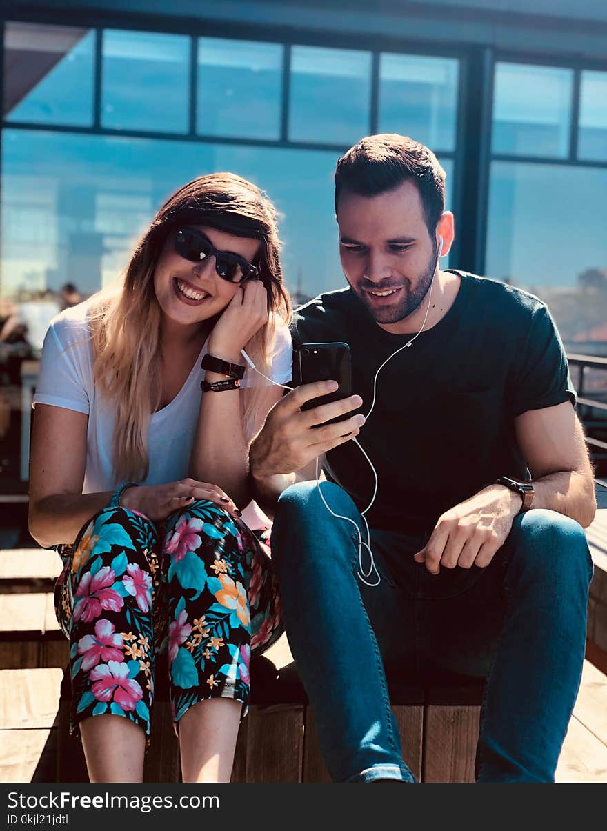 Man and Woman Using an Earphones