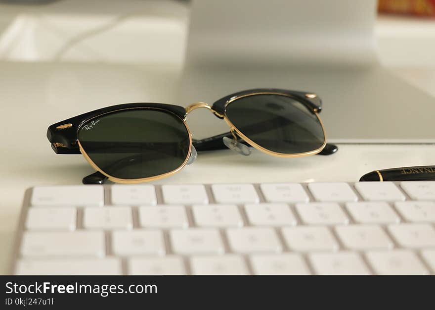 Black Ray-ban Clubmaster Sunglasses on White Surface