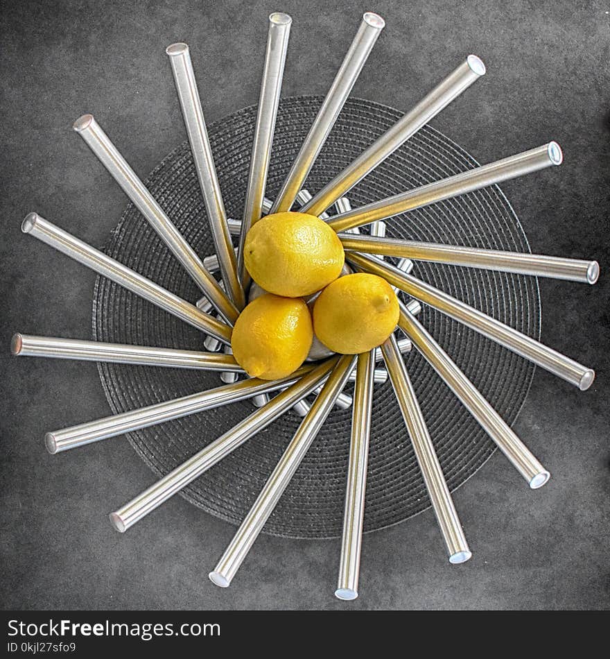 Three Lemon Fruits on Steel Bowl