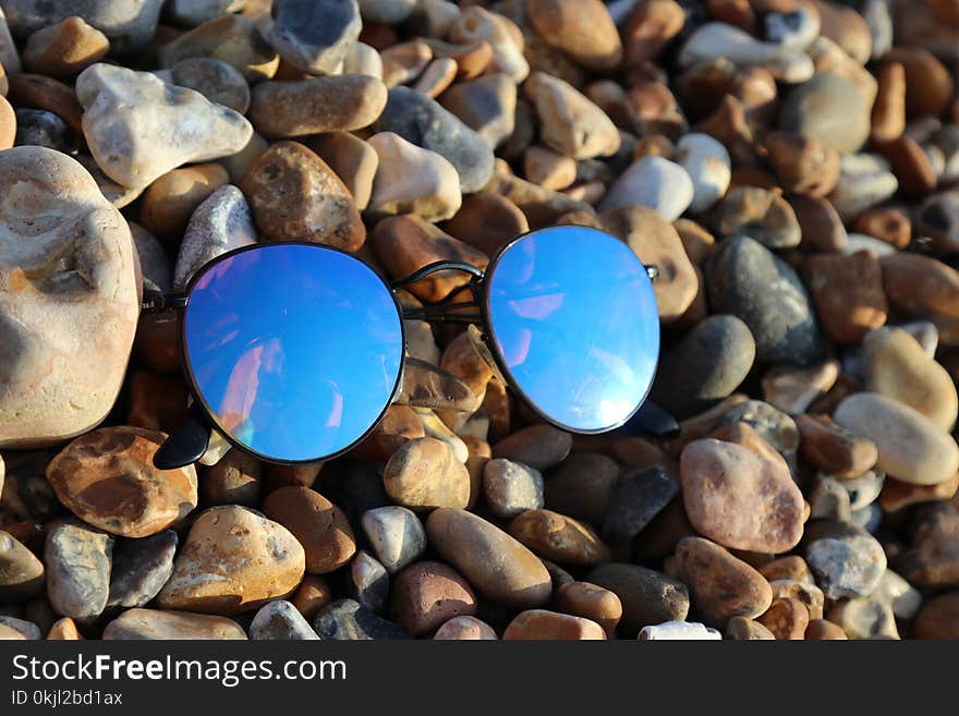 Black Farmed Sunglasses on Rocks