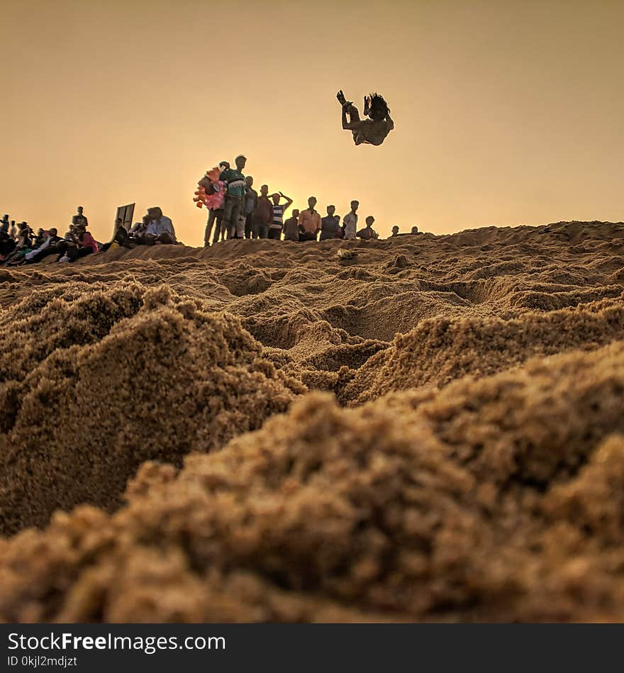 People Standing on Brown Sand