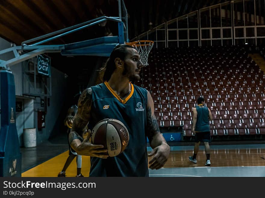 Man in Blue and Yellow Basketball Jersey Top