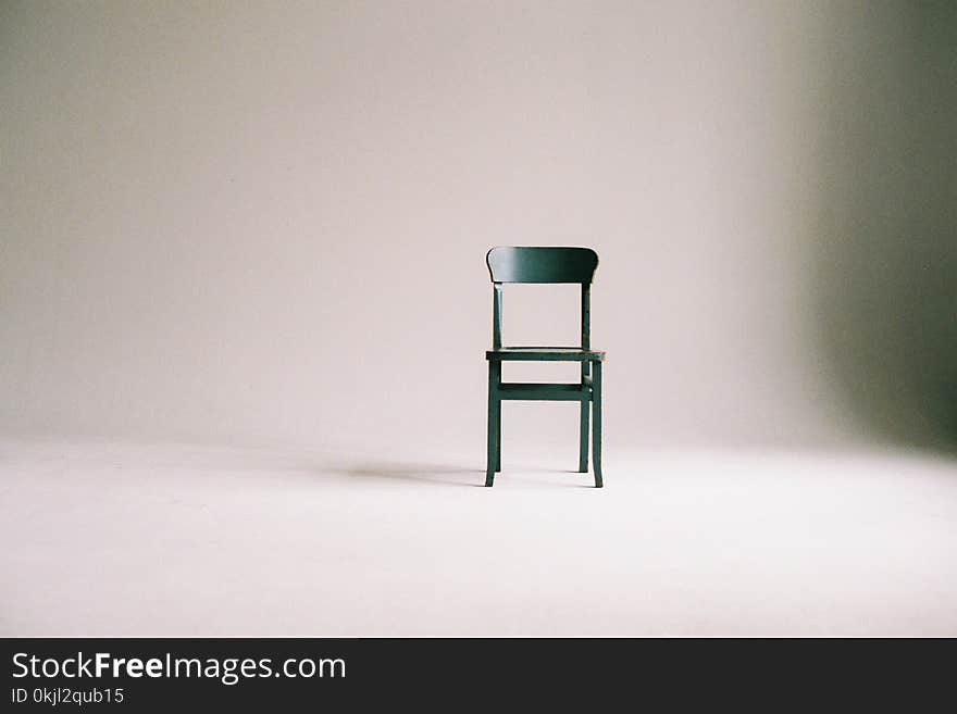 Green Wooden Chair on White Surface