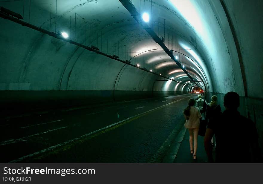 Group of Persons Passing by Tunnel