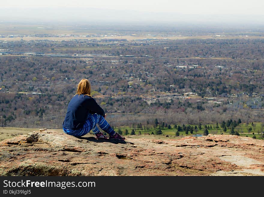 Person Seating on Brown Ground