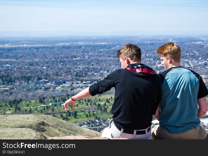 Two Men Sitting on Hill