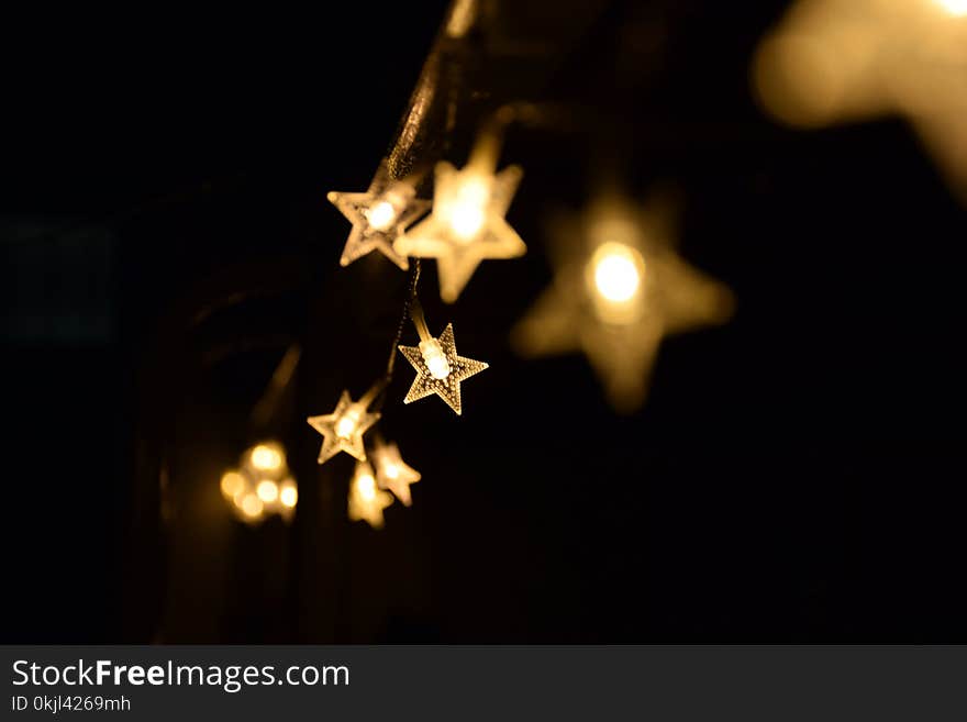 Shallow Focus Photography of Yellow Star Lanterns