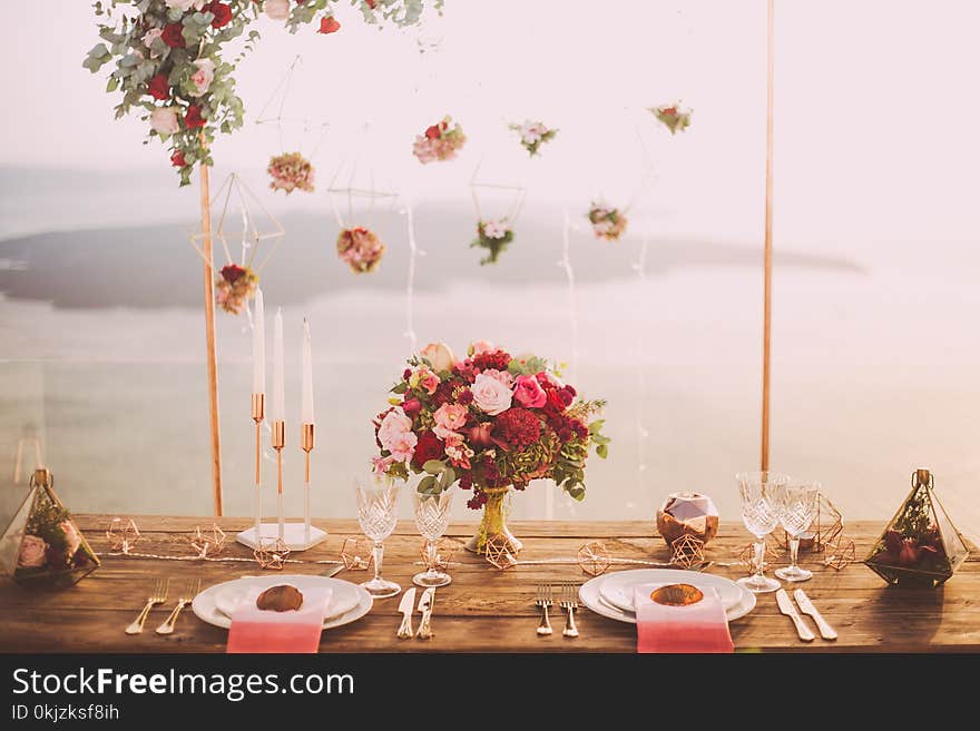 Pink and Red Roses Centerpiece Near Silverwares