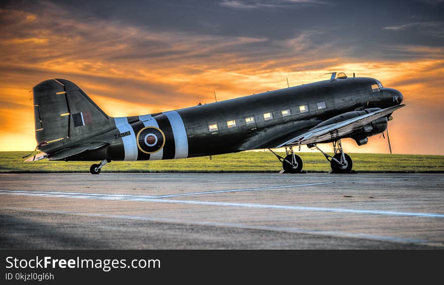 Photo of Black and White Airplane during Golden Hour