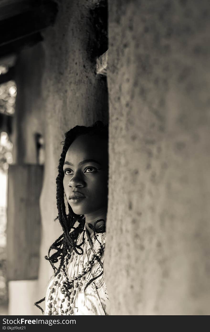 Grayscale Photo of Braided Woman Standing