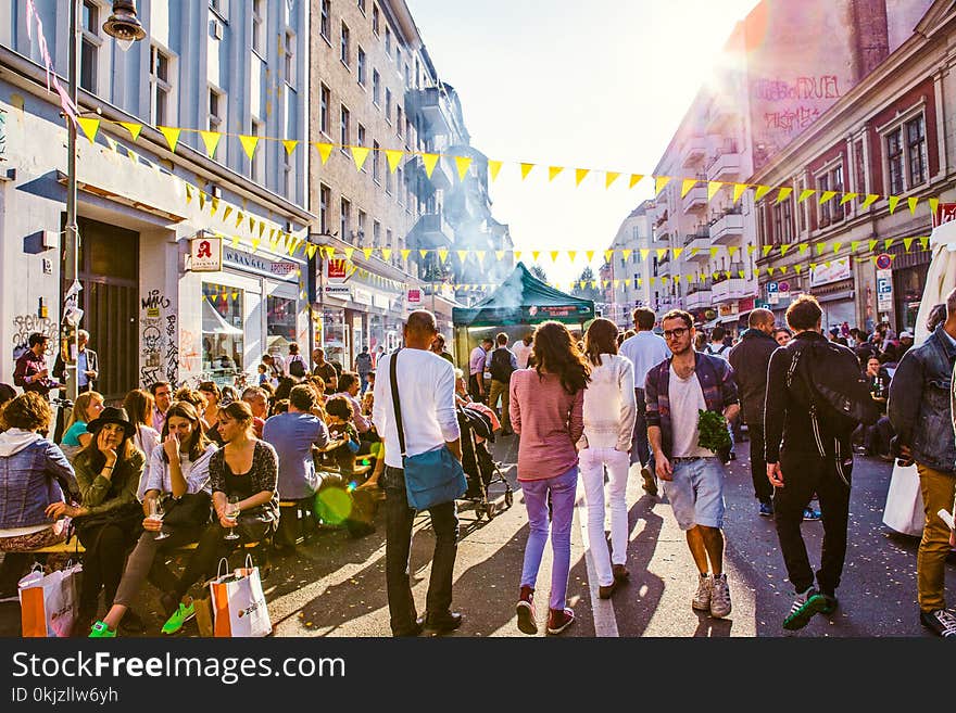 People Waling Near Gray Buildings