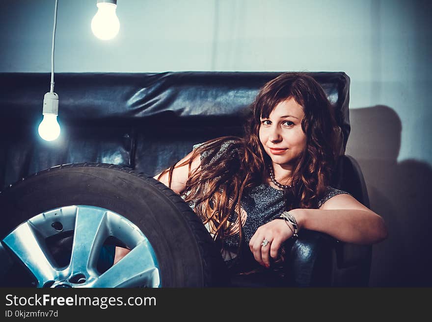 Photo of Woman Sitting on Couch Front of Wheel