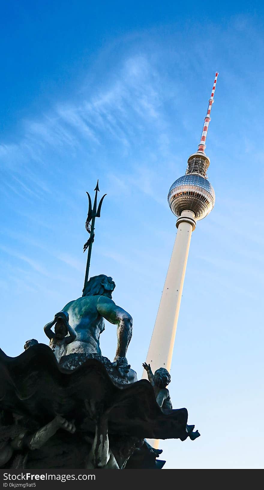 Low Angle Photo of Statue and Tower Structure