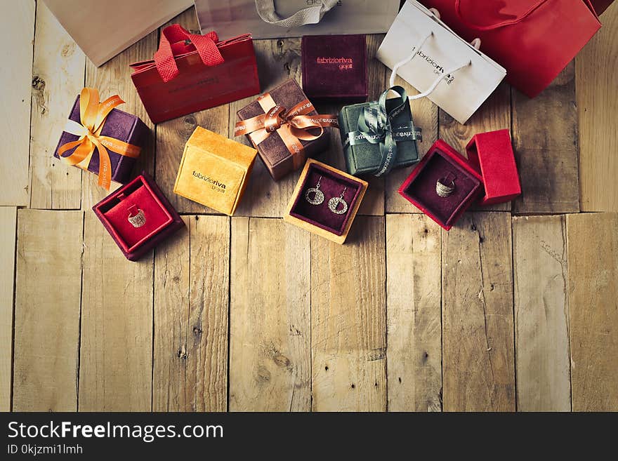 Assorted Gift Boxes on Brown Wooden Floor Surface