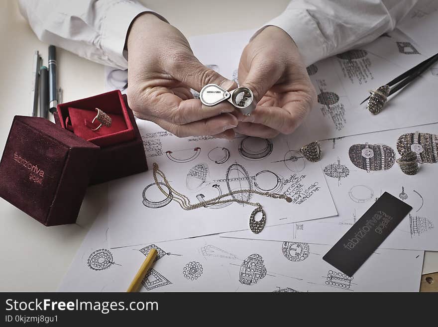 Person Holding Silver-colored Accessory Close-up Photo