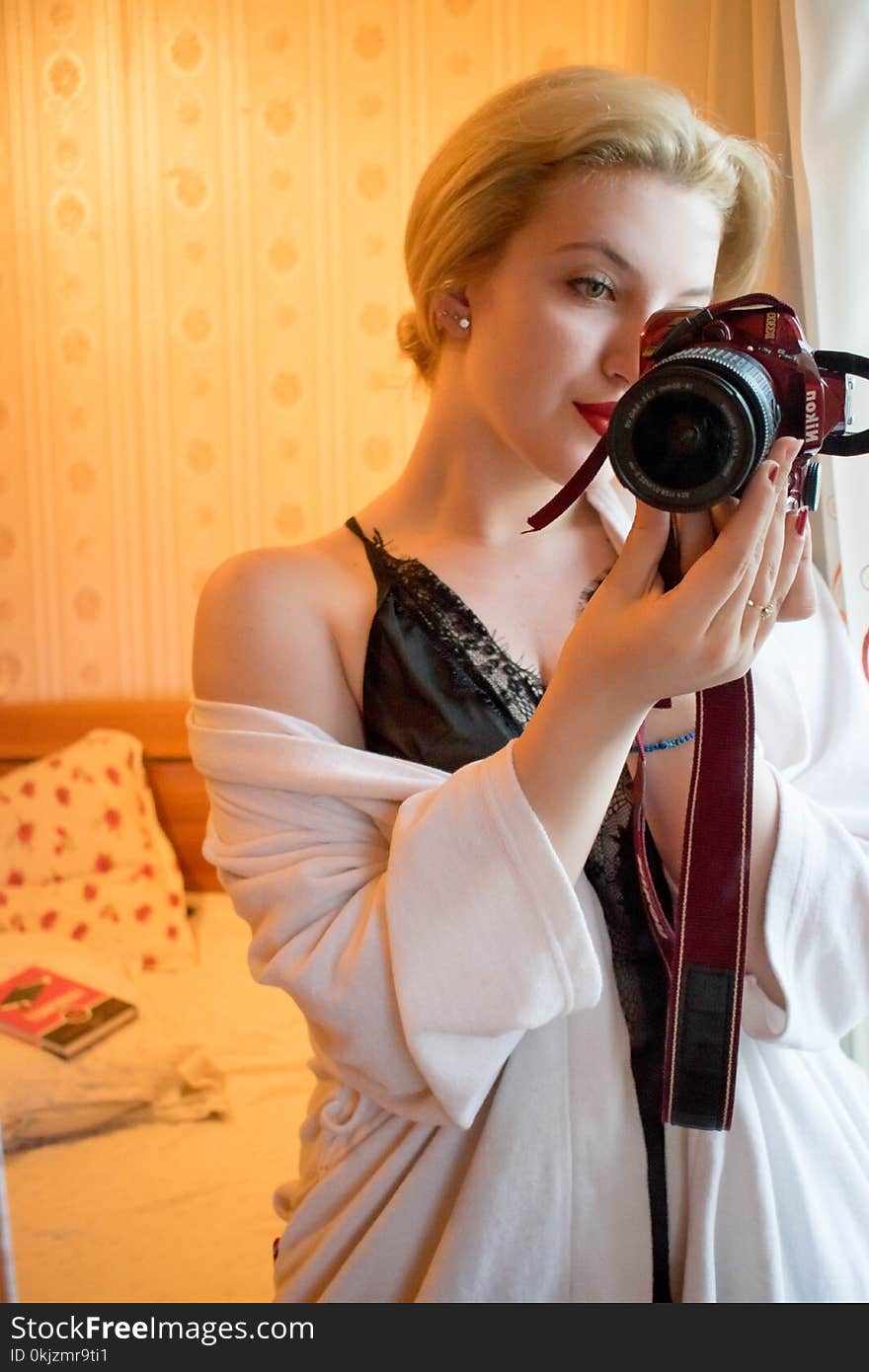 Woman Wearing Black Lace Floral Spaghetti Strap Dress Holding Black and Red Samsung Bridge Camera in Room