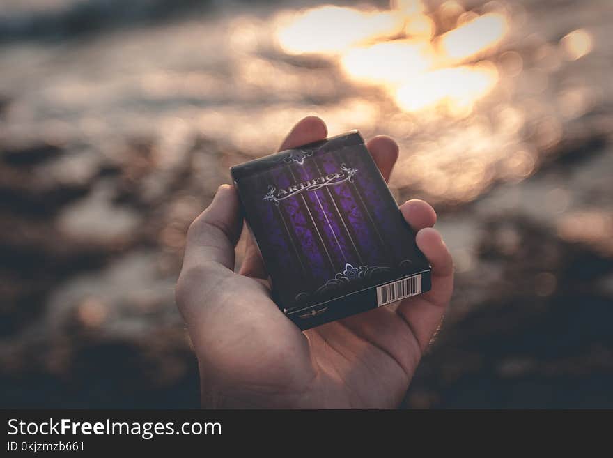 Person Holding Black Box