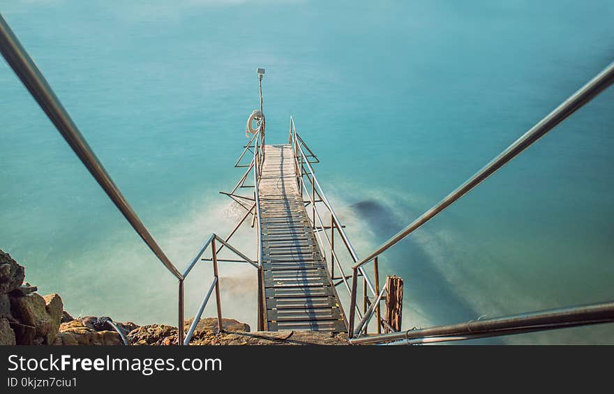 Brown Dock Bridge on Body of Water