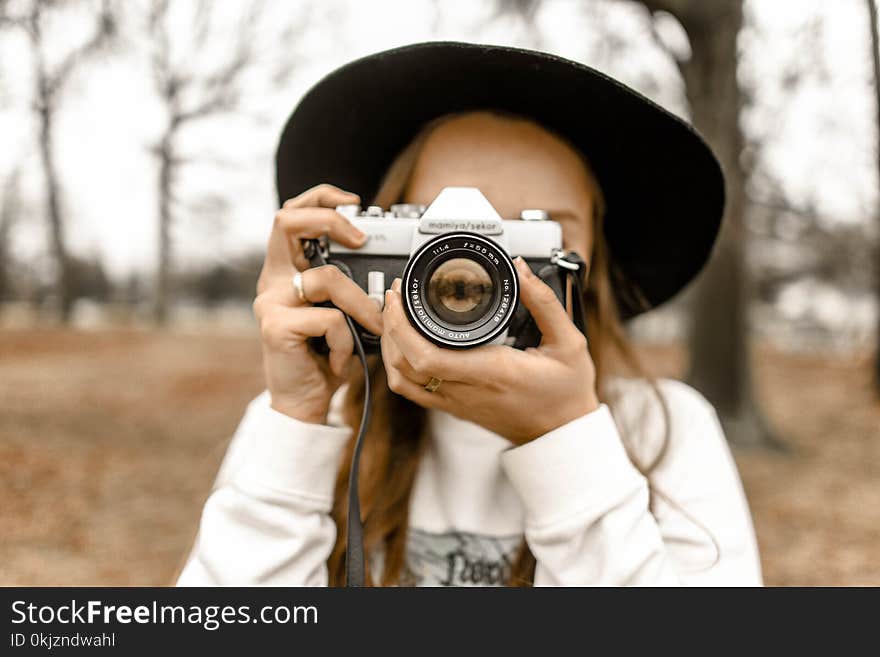 Selective Focus Photography of Woman Using White and Black Slr Camera