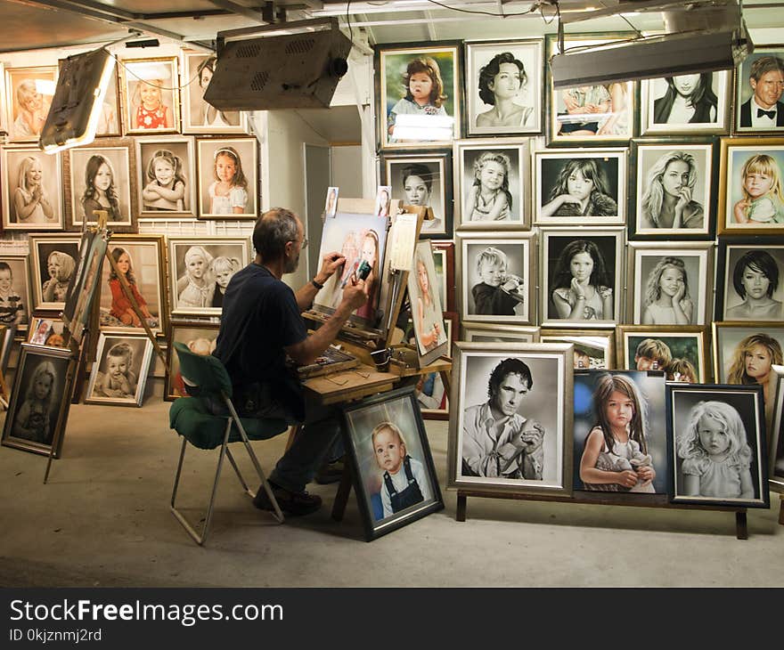 Man Sitting on Chair Painting Inside Room