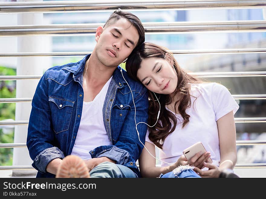 Asian couple tourist have music listening together.