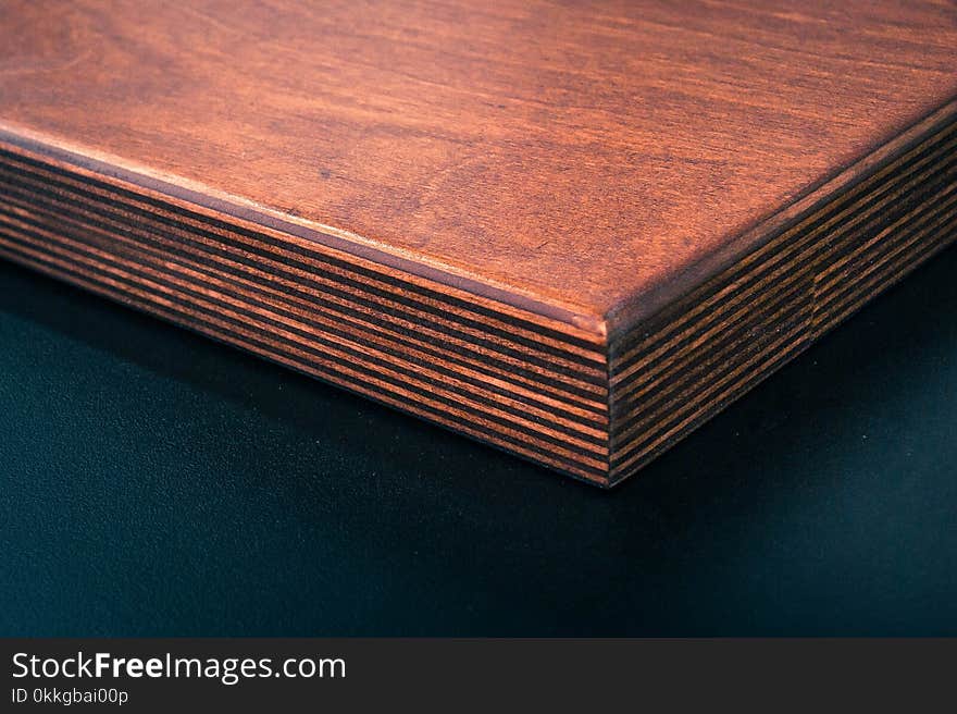 Brown Wooden Board Near Black Surface