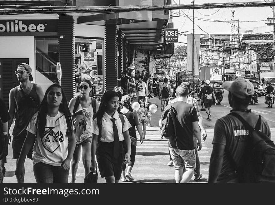 Grayscale Photo of People Walking in the Street