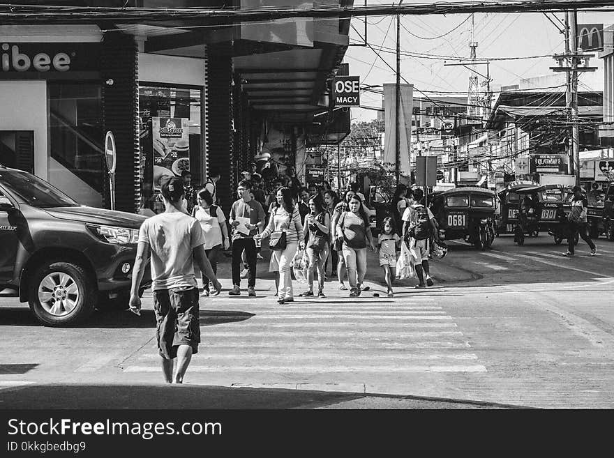 Monochrome Photography of People Crossing The Road