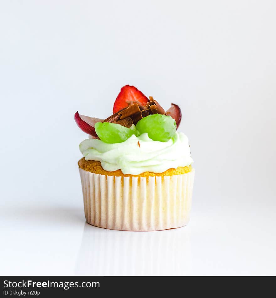 White and Yellow Cupcake With Fruit Toppings