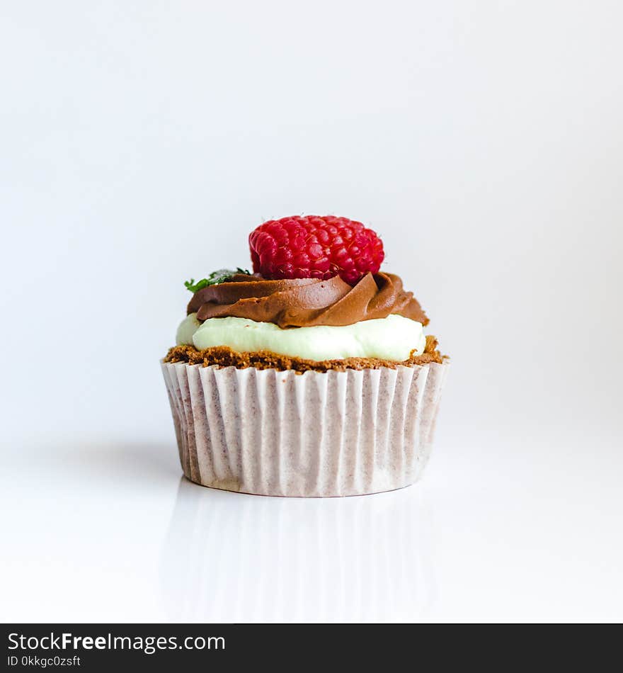 Photograph of Chocolate Cupcake With Red Strawberry Toppings