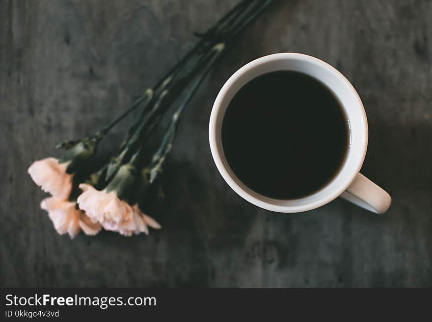 White Ceramic Mug Beside White Petaled Flower