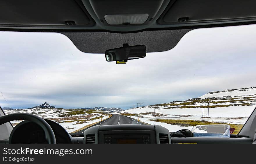 Vehicle in Between Snow Covered Field