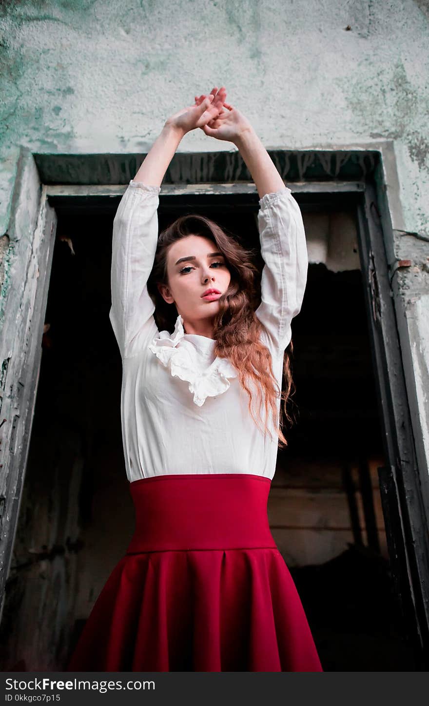 Woman Wearing White and Red Dress Raising Her Hands Up